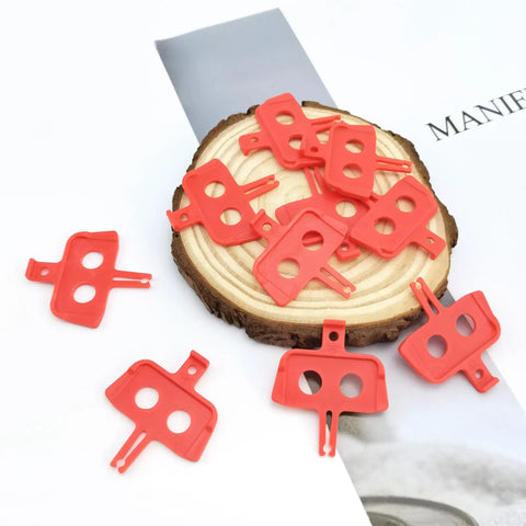 10 Pack Bike Disc Brake Pad Spacers And Pad Spreader Tool For Hydraulic Disc Brakes Keeps Pads From Closing When Lever Is Pulled Durable Plastic Inserts For Mountain And Road Bikes Orange, arranged on a wooden surface