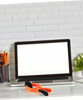 Laptop on desk with Phone Screen Opening Tool With Suction Cup Pliers For Easy DIY Repairs placed in front, showing tool's size and design.