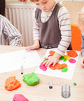 Children using Twenty Piece Circle Clay Cutter Set With Stainless Steel Ring Molds for clay and dough activities on table