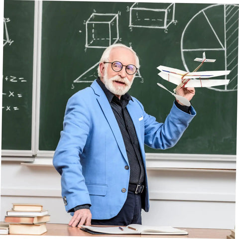 Man in blue blazer holding model plane near chalkboard with geometric drawings, showcasing 5 Piece RC Airplane Propeller Blades Rad High Performance Rubber Band Powered Gear for Model Planes Easy Install for Aircraft Gliders and Remote Control Planes Compatible with Various RC Aircraft.