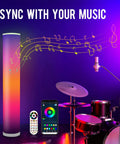 Two Pack RGB Floor Lamps With Music Sync App Control in a music-themed room with instruments and vibrant lighting display