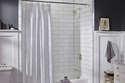 Elmhurst Shower Trim Kit With Tub Spout In Brushed Nickel Finish installed in modern bathroom with white tile and shower curtain