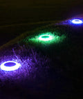 Colorized Solar Ground Lights With 20 Lumens Dope Outdoor RGB LEDs for Pool Area, Pathway, Patio showing purple and green glow at night