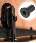 Close-up of Heavy Duty Barn Door Track Spacers Set Of 5 Beefy Wall Mount Supports For Sliding Barn Doors in use on track