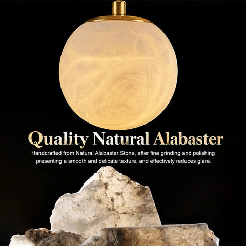 Close-up of a Natural Marble Globe Wall Light in alabaster with gold accents, showcasing smooth texture and illumination.