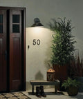 Ripley 10 Inch Wide One Light Outdoor Wall Light In Olde Bronze Finish illuminating porch with rustic style lantern and plants