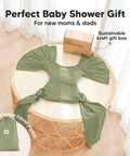 D Lite Baby Wrap Carrier Ring Sling in green on a table with gift box and travel pouch, showcasing ergonomic comfort and breathable fabric.