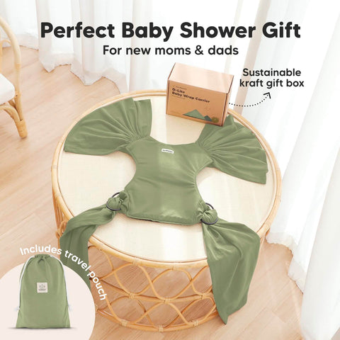 D Lite Baby Wrap Carrier Ring Sling in green on a table with gift box and travel pouch, showcasing ergonomic comfort and breathable fabric.