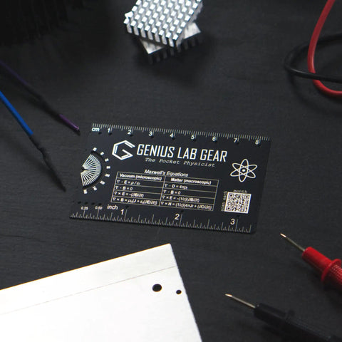 Mini Physics Multi Tool Ruler With Protractor And Compass Stainless Steel Gadget on dark desk with lab equipment