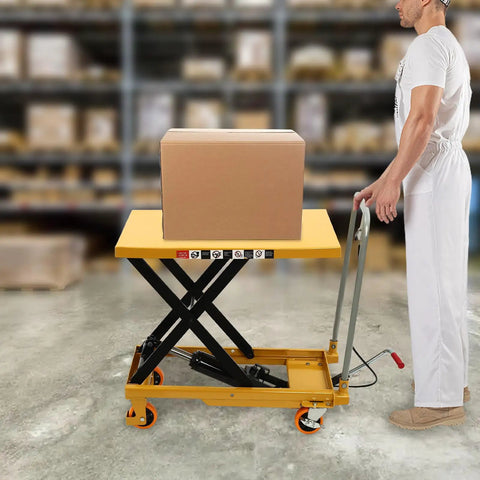 Solid Frame Hydraulic Scissor Lift Table Cart With Five Hundred Pound Capacity And Four Quiet Rollers raising a box in a warehouse.