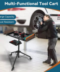 Rolling Tool Cart With Adjustable Height Work Table On Wheels in use in an auto shop with mechanic, features dual trays.