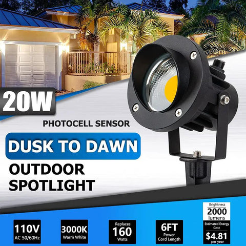 Outdoor Led Spotlight With Dusk To Dawn Sensor 20W 2000 Lumen Super Bright 3000K Warm White Waterproof Landscape Lights For Your Yard Garden Tree Flag Decor 6 Ft Cord Two Pack shown in front of illuminated house facade