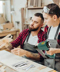 Father and son using Heavy Duty 1400 Piece 18 Gauge Brad Nails Kit for pneumatic and electric nailers during woodworking.