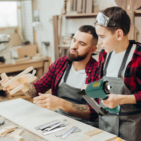 Father and son using Heavy Duty 1400 Piece 18 Gauge Brad Nails Kit for pneumatic and electric nailers during woodworking.