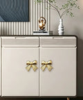 Six Piece Zinc Alloy Bow Drawer Knobs With Vintage Plating And Smooth Curved Handles For Dressers And Vanity Furniture Upgrades That Bring Main Character Energy To Your Space on a sideboard with a modern design.