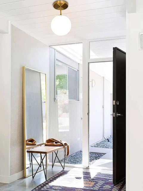 Mid Century Modern Ceiling Light Fixture With Milk Glass Shade And Matte Gold Finish Semi Flush Mount in an entryway