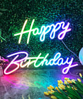 Extra Large Neon Happy Birthday Sign With Multi Color LED Lights Light Up Backdrop For Parties on green foliage wall