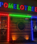 Smoke shop storefront with Lit RGB Window Lights For Storefronts 12V Waterproof LED Modules, colorful borders on windows.