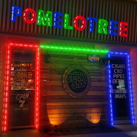 Smoke shop storefront with Lit RGB Window Lights For Storefronts 12V Waterproof LED Modules, colorful borders on windows.