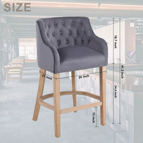Grey suede counter height stool with natural wood legs, 24-inch tall, button-tufted backrest, shown in a modern kitchen setting