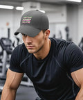 Man in gym wearing Dope Dark Gray Adjustable Baseball Cap For Men With Classic Fit, Easy Buckle, Everyday Street Style, Lightweight Comfort.