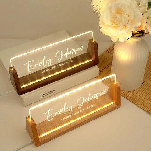 Personalized Acrylic Desk Name Plate With Light Up Base featuring Emily Johason, Marketing Manager, on wooden LED base