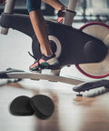 Comfy Armrest Pads for Indoor Cycling Bikes, 2-Piece EVA Cushioning System shown beneath a stationary bike setup.