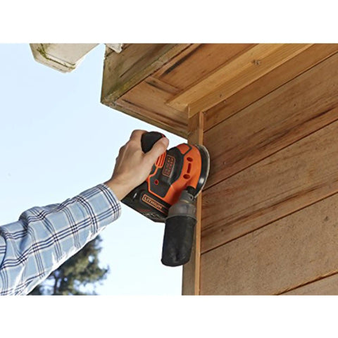 Badass 18V Cordless Orbital Sander With Killer Dust Control And Super Smooth Softgrip Handle For Hassle Free Wood Projects 12,000 Opms Compact Orange Design Includes Four Piece Accessories Set For Top Shelf Finishing Results in use on wooden trim.
