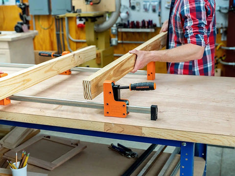 Heavy Duty 36 Inch 90 Degree Parallel Steel Bar Clamp For Woodworking And Cabinet Build With Multi Plate Clutch Mechanism in use holding wood.