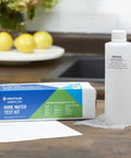 Convenient OMNIFilter Mail Home Water Test Kit with sample bottle and instructions on wooden table.