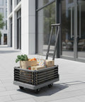 Foldable Grocery Trolley With Basket Hand Push Cart With Long Handle And Detachable Panel, Quiet Swivel Wheels, Lightweight Black Utility Wagon For Shopping And Your Everyday Hauls On The Go. Black slatted foldable trolley with long handle, loaded with groceries outdoors