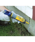 Concrete Crack Filler And Sealer Ready To Use 10 Oz Tube being applied to vertical concrete surface for repair