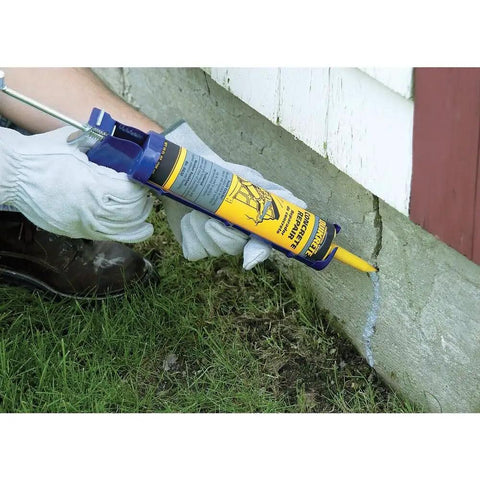 Concrete Crack Filler And Sealer Ready To Use 10 Oz Tube being applied to vertical concrete surface for repair