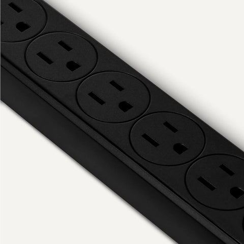Dead Simple Dual Pack Six Outlet Surge Protector Power Strip With Six Hundred Joule Protection Circuit Breaker Safety Shutters And A Sleek Two Foot Black Cord For Desk Setup, showing a close-up of six black outlets.