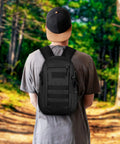10L Tactical Backpack Small Daypack With MOLLE Rucksack Gear For Hunting Camping Trekking Black Compact EDC Bag on person in forest