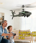 Child and man playing with RC Helicopter For Beginners With Altitude Hold Gyro Stabilization And LED Lights indoors, green model.
