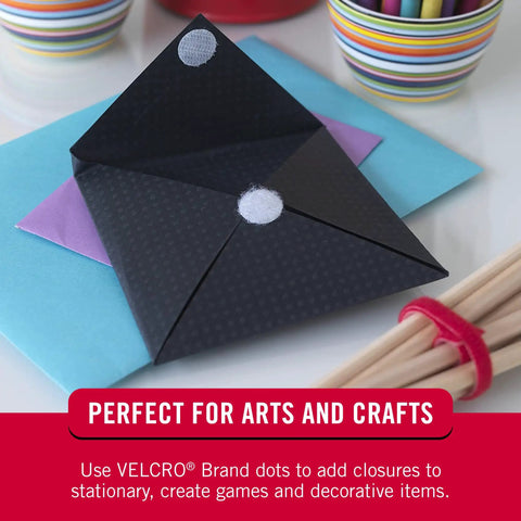 Top Notch Peel And Stick Hook And Loop Fastener Dots Beige Medium Three Quarter Inch Circles for arts and crafts on black envelope.