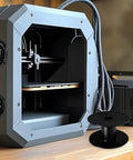 Super Slick Empty Cable Winder Reel 165mm Plastic Cord Organizer for Tangled Wire Storage next to a 3D printer setup