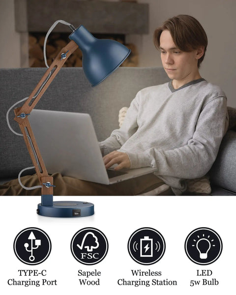 Sapele Wood Desk Lamp With Upgraded Wireless Charger And USB C Port Swing Arm Reading Light in a dope blue finish next to a user on a laptop.