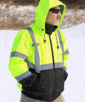 Man wearing Waterproof Lime Hi Viz Fleece Bomber Workwear Jacket With Detachable Hood Five Pockets Radio Pocket with snow background