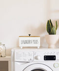 Farmhouse Style Wooden Laundry Pods Container With Lid Rustic Detergent Storage Organizer Box Pod Caddy atop a washing machine