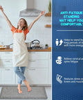 Woman standing on No Slip 0.875 Inch Thick Anti Fatigue Kitchen Floor Mat in light gray, highlighting ergonomic comfort and durability.