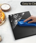 Chef Grade 22 Pound 10 Kilogram Digital Kitchen Scale With 0.1 Ounce And 1 Gram Precision LED Backlit Display Three AAA Battery Powered Black For Cooking And Baking Top Notch Pro Factory Quality Since 2001 Weighs Grams And Ounces being cleaned with a cloth, showing easy maintenance.