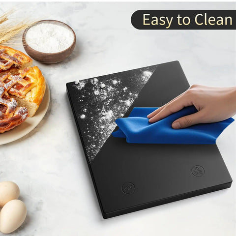 Chef Grade 22 Pound 10 Kilogram Digital Kitchen Scale With 0.1 Ounce And 1 Gram Precision LED Backlit Display Three AAA Battery Powered Black For Cooking And Baking Top Notch Pro Factory Quality Since 2001 Weighs Grams And Ounces being cleaned with a cloth, showing easy maintenance.