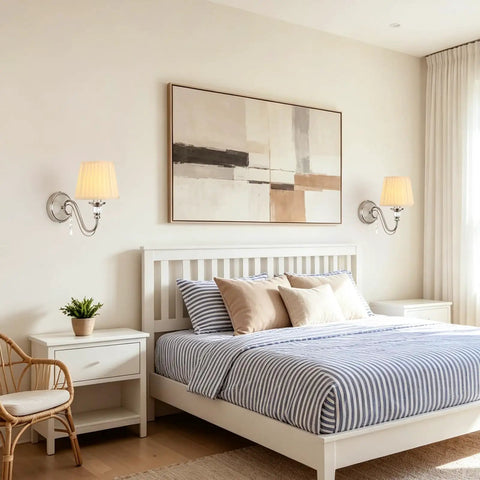 1-Light Brushed Nickel Vanity Light with Beige Fabric, Modern Wall Sconce above a white bed with striped bedding.