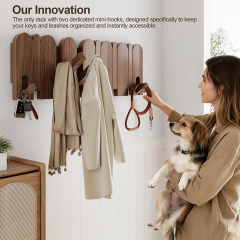 Woman using Walnut Wood Coat Rack Wall Mount With Eight Retractable Hangers And Two Dedicated Key Hooks in entryway