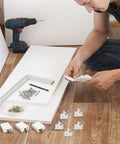 Person assembling furniture with 120 Pcs Drawer Bottom Support Brackets With Screws Plastic Drawer Wedges And Corner Brackets Repair Kit.