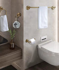 Bathroom setting with antique brass accessories set, towel holder, and toilet paper holder. All In One Antique Brass Bathroom Accessories Set With 24 Inch Towel Holder And Wall Mount Hardware Comes With Double Towel Bar, Toilet Paper Holder, Hair Dryer Holder, Toilet Brush Holder, Towel Ring, Double Robe Hook And Soap Dish For Sleek Spa Vibe.