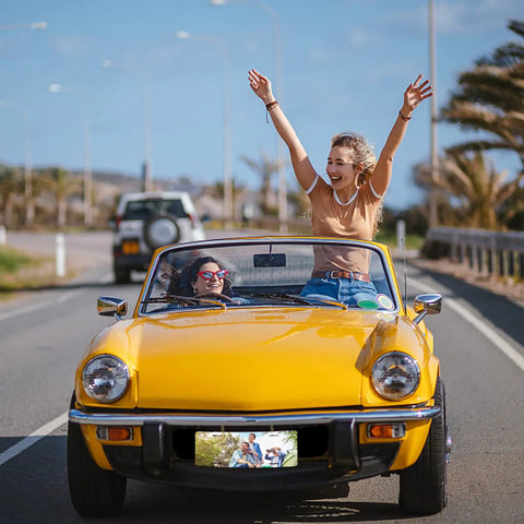 Two people enjoying a ride in a yellow convertible with a 10 Pack Sublimation License Plate Blanks 12x6 Inches 0 65mm Thick White Aluminum.