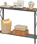 Smooth Vibes Two Tier Industrial Console Table With Open Storage Shelves For Tight Hallways Rustic Wood Surface Heavy Steel Legs Built Damn Tough No Hassle Setup Living Room Corner Unit with decorative items and storage below.